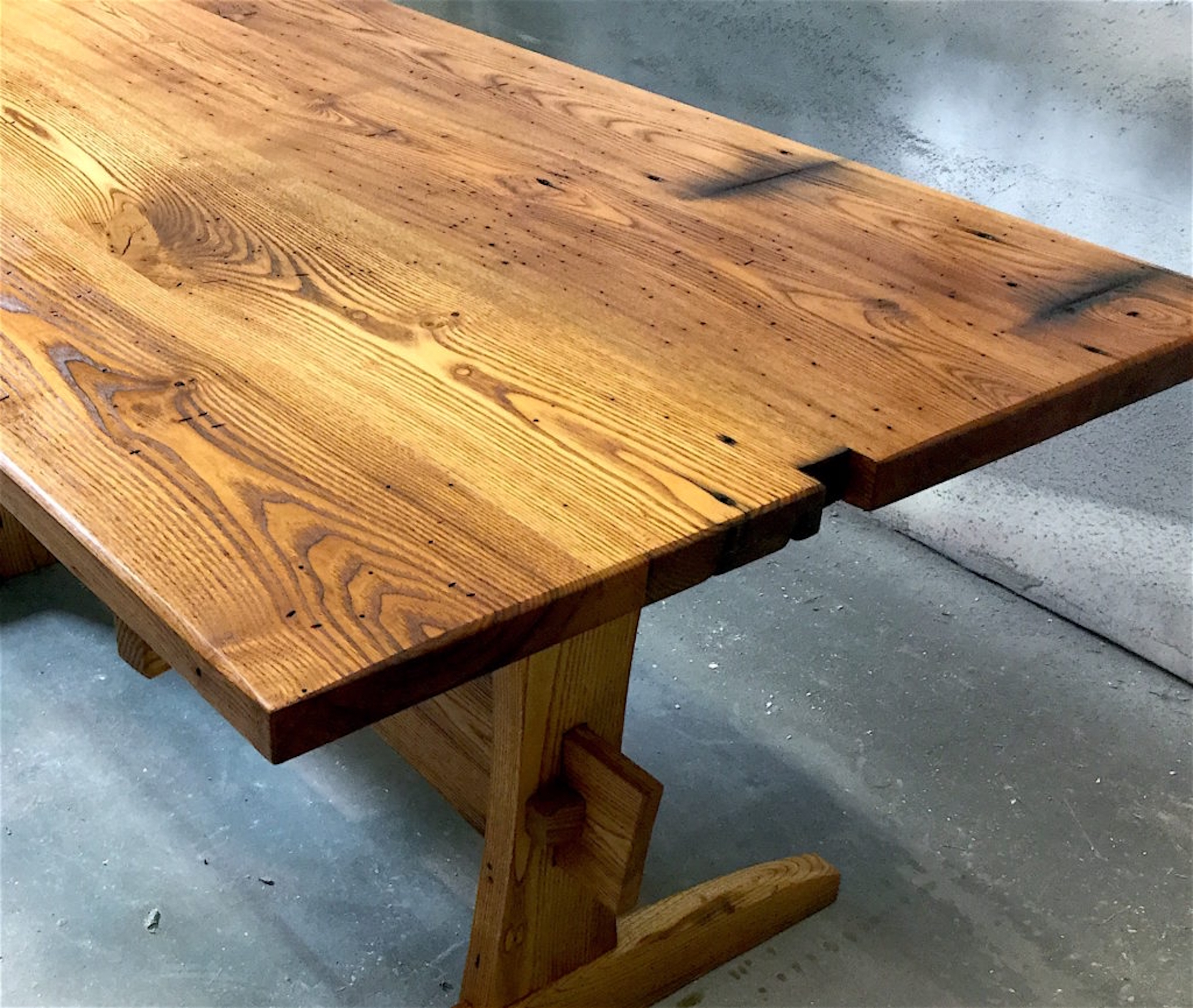 Trestle-style table made from reclaimed chestnut lumber sourced by Rousseau Reclaimed Lumber & Flooring in South Portland, Maine