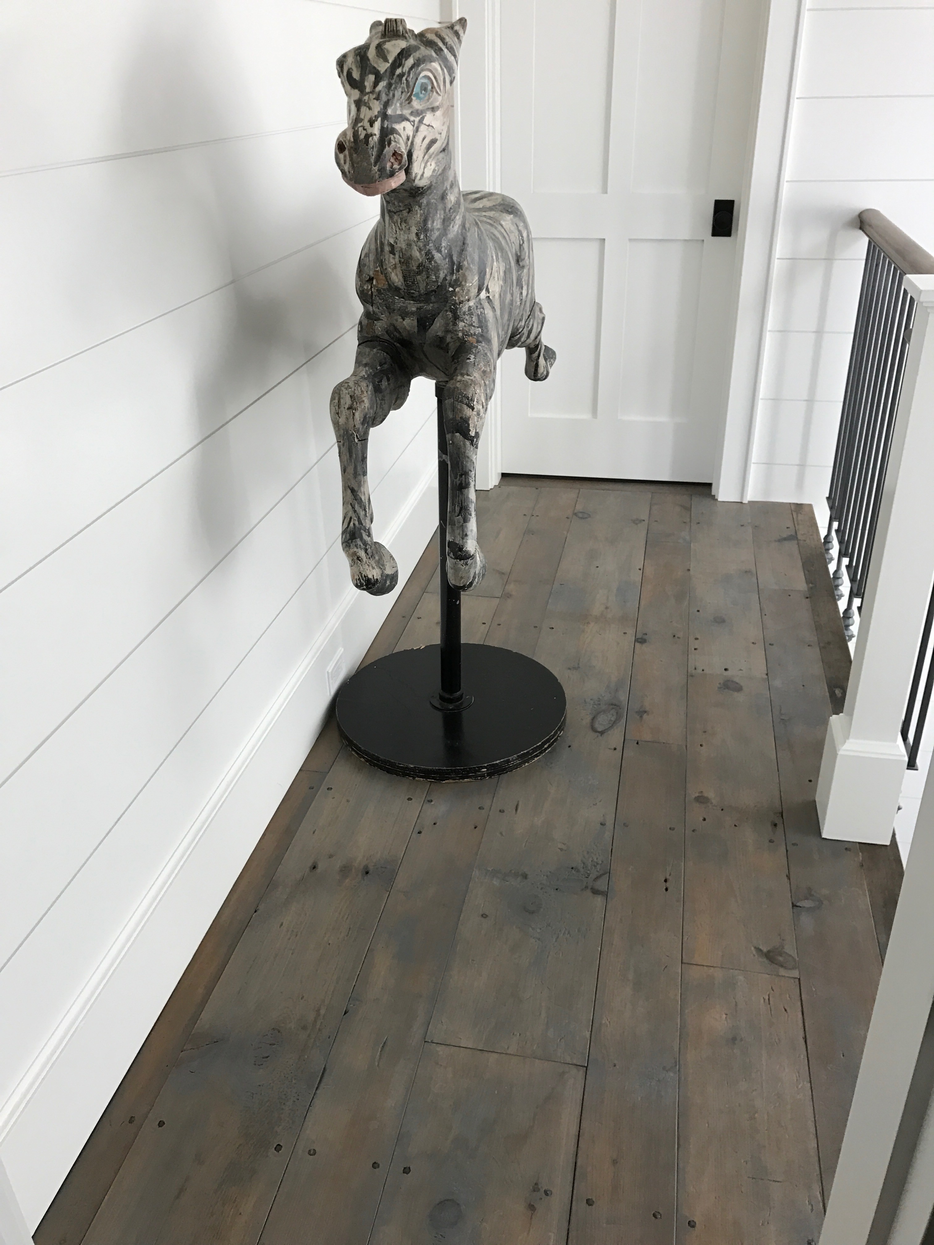 Hallway featuring antique white pine flooring in a residence in Pemaquid, Maine, sourced by Rousseau Reclaimed Lumber & Flooring