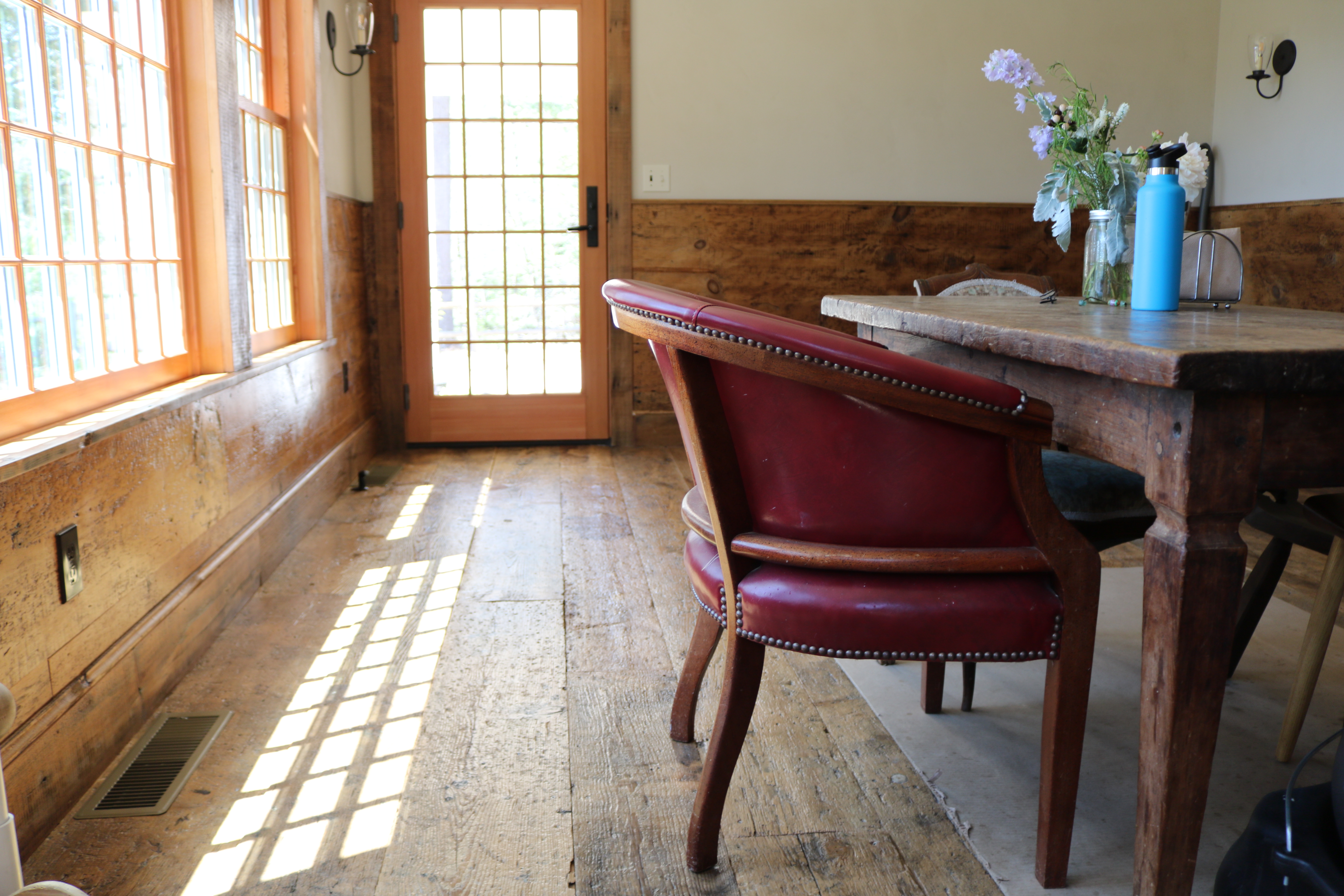 Dining room in a residence in Yarmouth, Maine, featuring barn board flooring from Rousseau Reclaimed