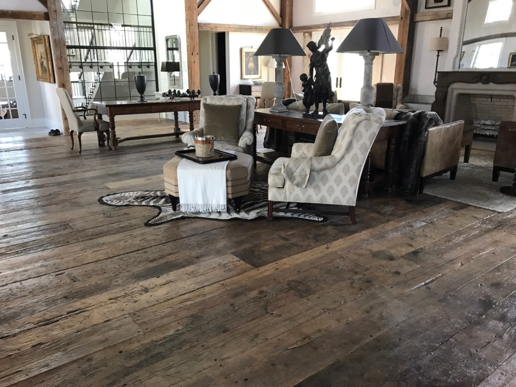 Spacious living room featuring original surface flooring made from reclaimed barn board in a residence in Pemaquid, Maine